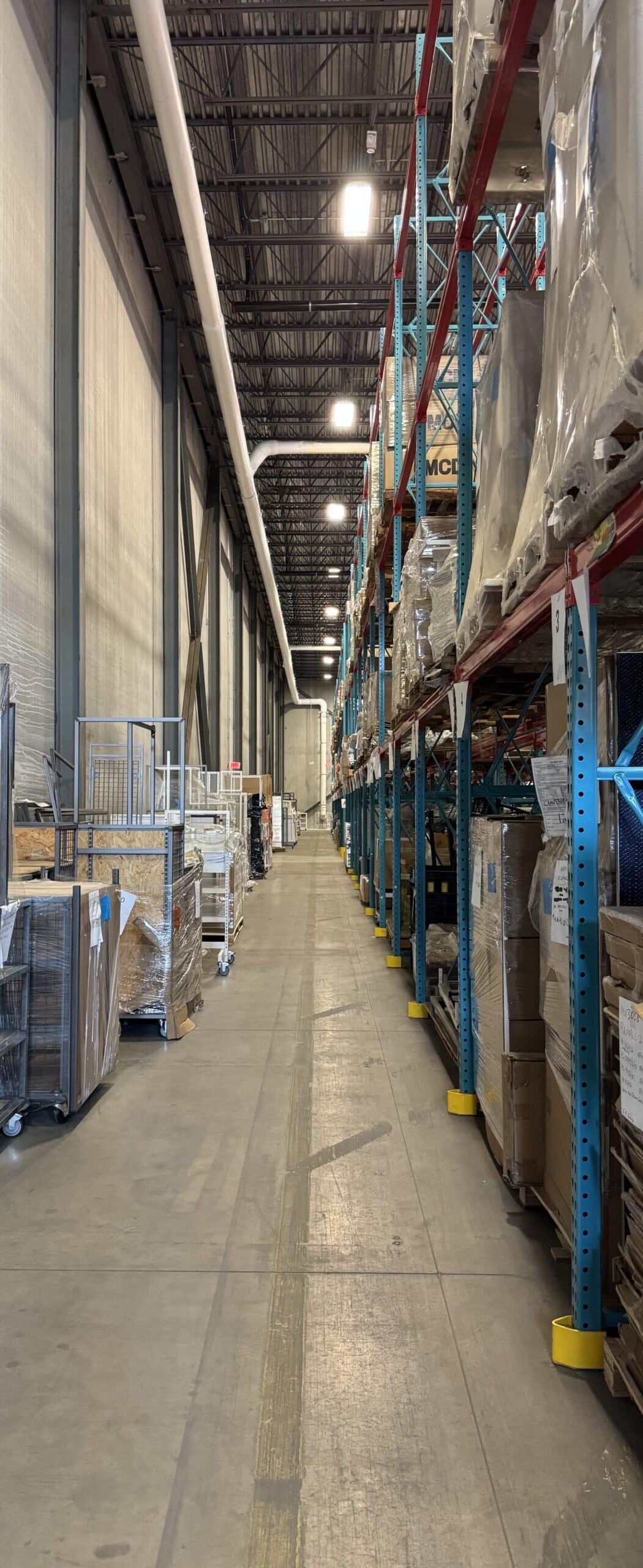 Long warehouse aisle with racked pallets at the Pez Logistics facility in Dayton, NJ